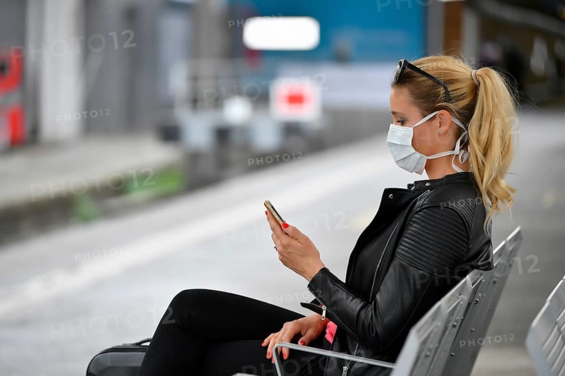 Woman with face mask, waiting for train