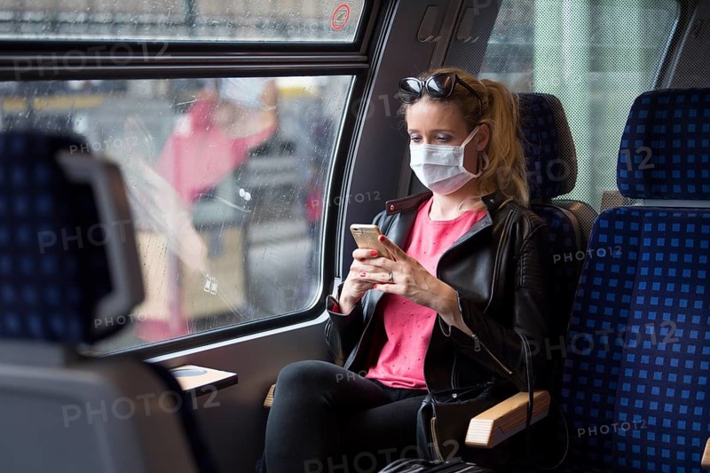 Woman with a face mask, sitting in Zug