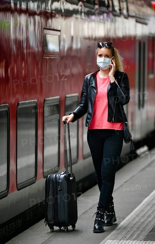 Woman with face mask, waiting for train