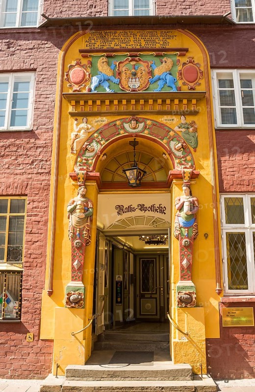 Decorative entrance with coat of arms and figures