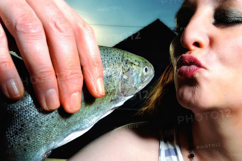 Woman kissing a fish
