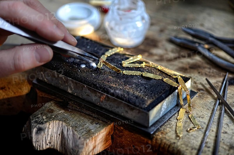 Goldsmith working on golden chain