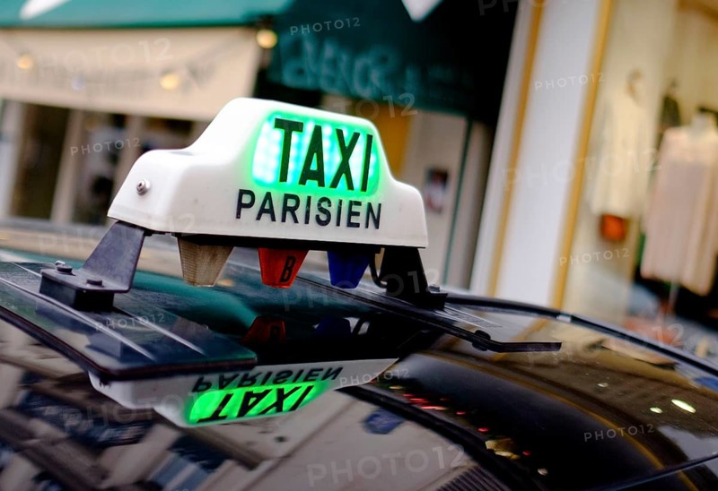 Sign of a Parisian taxi reflected in the roof