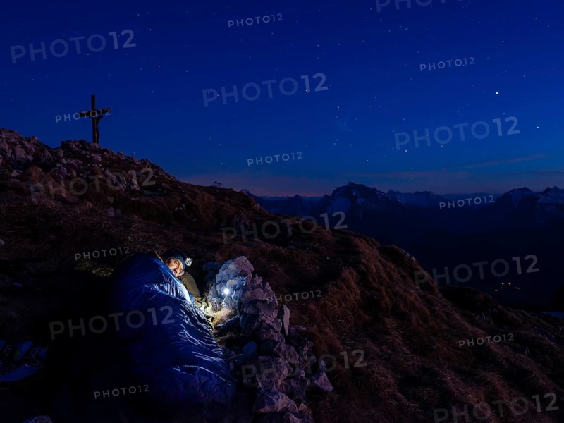 Mountaineer bivouacs at the summit of the Berchtesgadener Hochthron