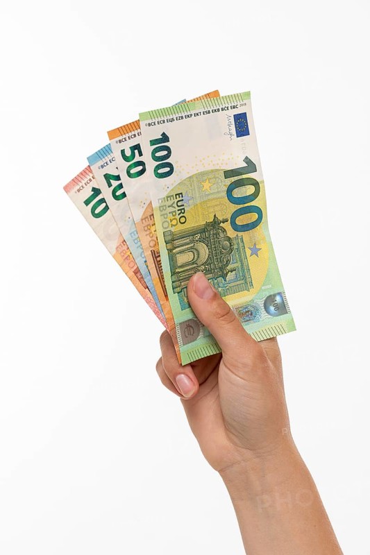 Woman holding fanned euro banknotes in her hand