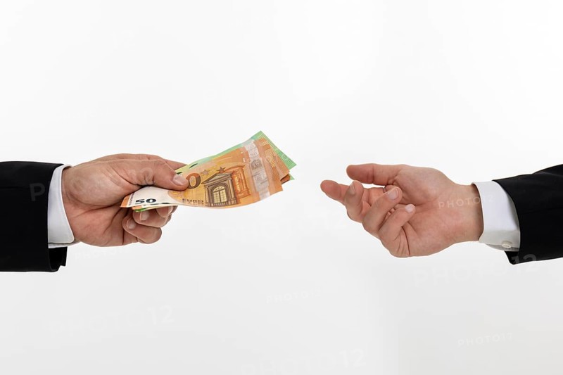 Businessman hands over banknotes