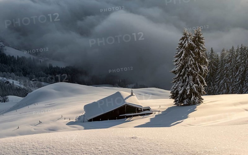 Snow-covered hut in the morning sun