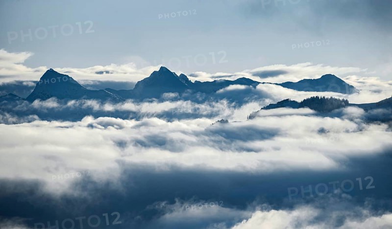 View of mountains between clouds