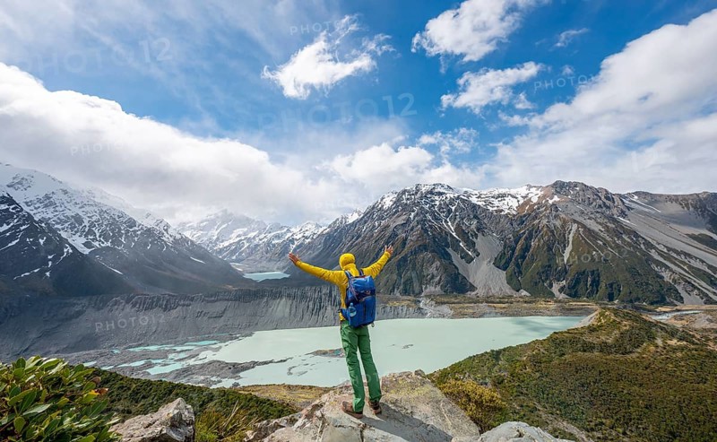 Hiker stretches his arms in the air