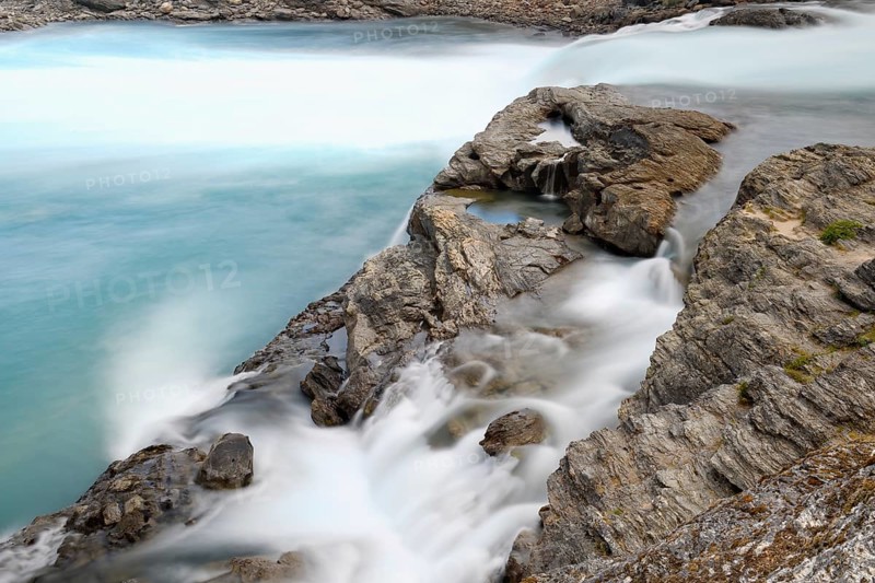 Rapids at the confluence of blue Baker river and grey Neff river