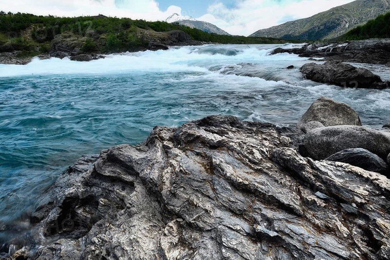 Rapids at the confluence of blue Baker river and grey Neff river