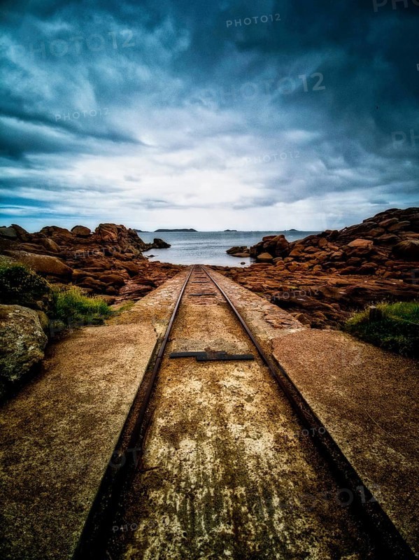 Rusty tracks into the sea