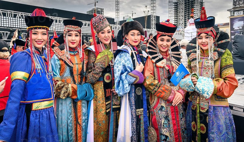 Beautiful young ladies staying in Mongolian traditional costumes of different ethnic groups in the central square
