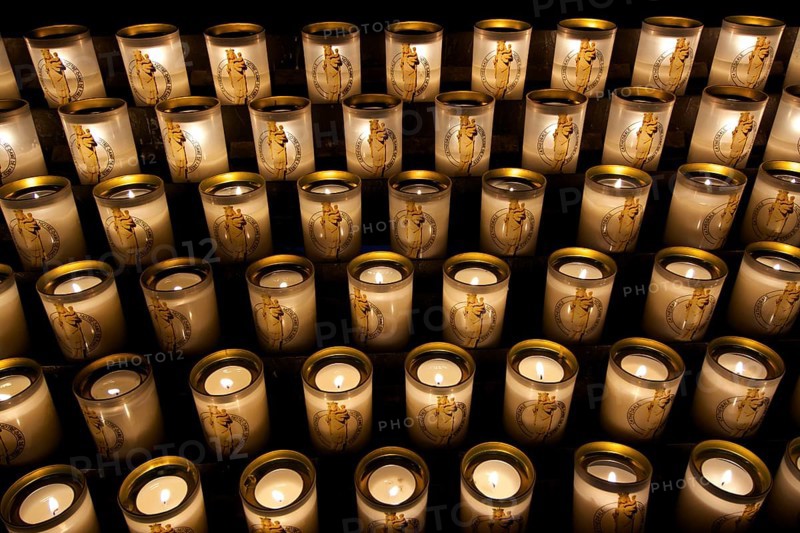 Many burning sacrificial candles