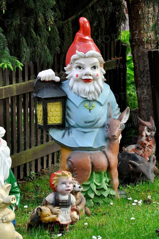 Garden gnome with lantern and deer