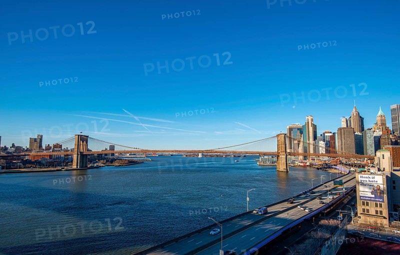 View from Manhattan Bridge over the East River to the skyline of Lower Manhattan and Brooklyn Bridge