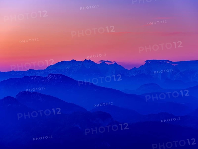 Blue mountain silhouettes at sunrise