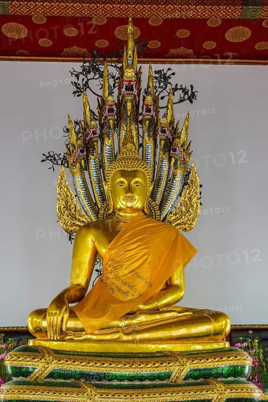 Buddha meditating under the protection of a seven-headed Naga snake