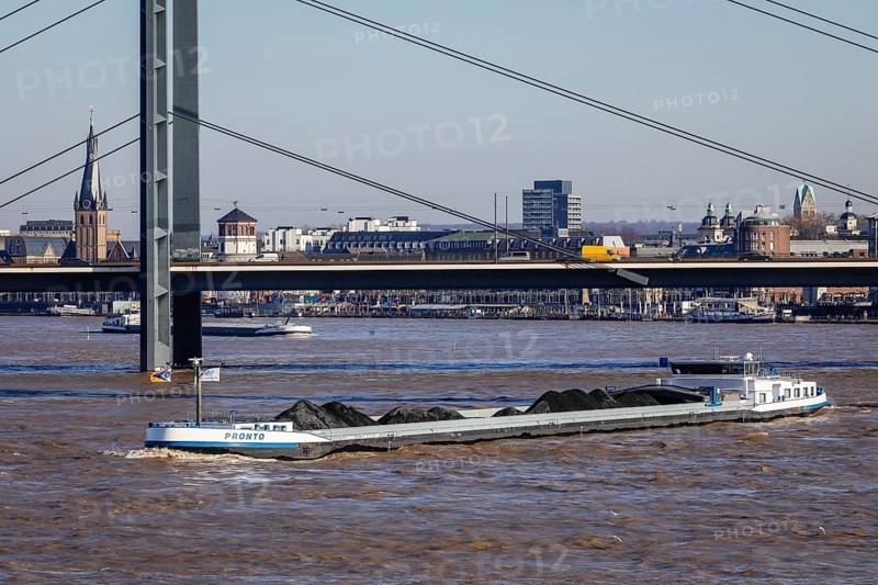 Freighters navigating at high water on the Rhine under the Rheinkniebruecke