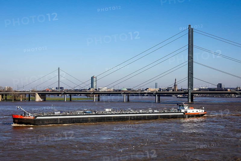 Freighters navigating at high water on the Rhine under the Rheinkniebruecke