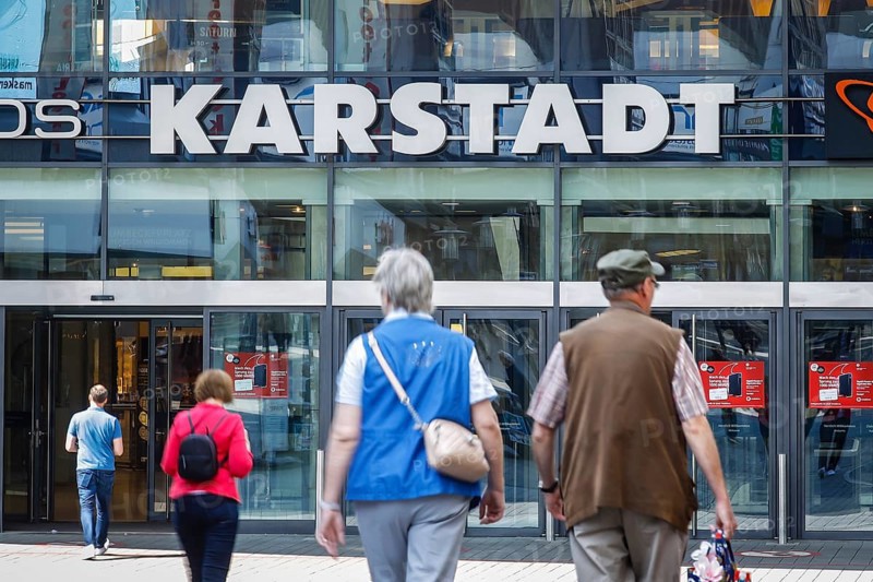 Passers-by in front of the entrance of the Galeria Karstadt Kaufhof store in the Limbecker Platz shopping centre