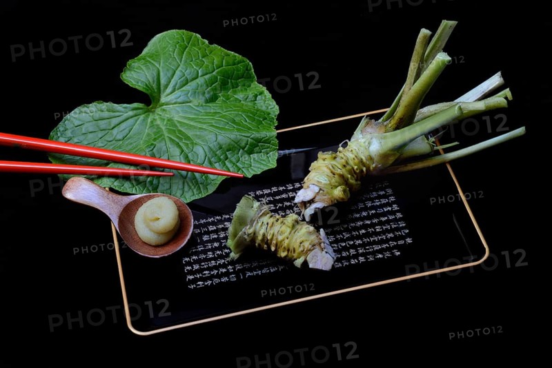 Wasabi root and wasabi paste on tray with chopsticks