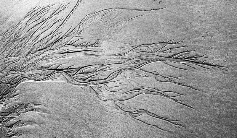 Meandering pattern of run-off water in sand
