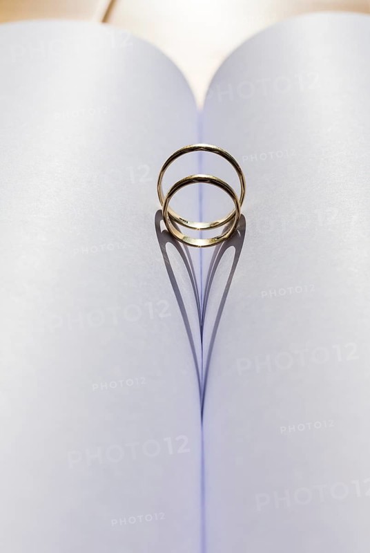 Two wedding rings in the fold from an empty book