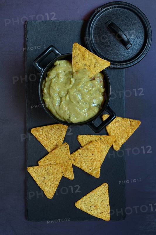 Guacamole in pot and tortilla chips