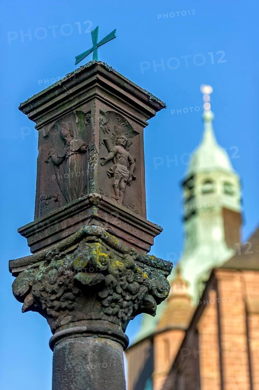 Wayside shrine in front of the neo-gothic collegiate church of St. John the Baptist