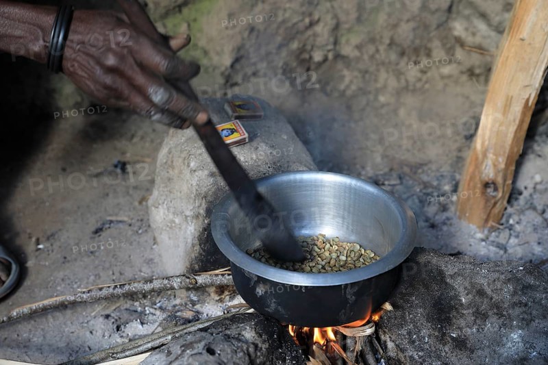 Woman preparing coffee over the fire