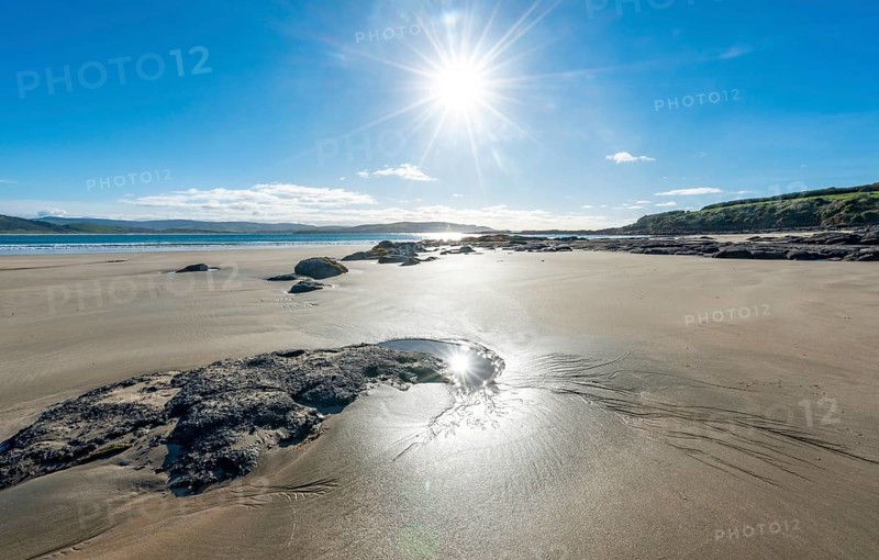Stones on sandy beach