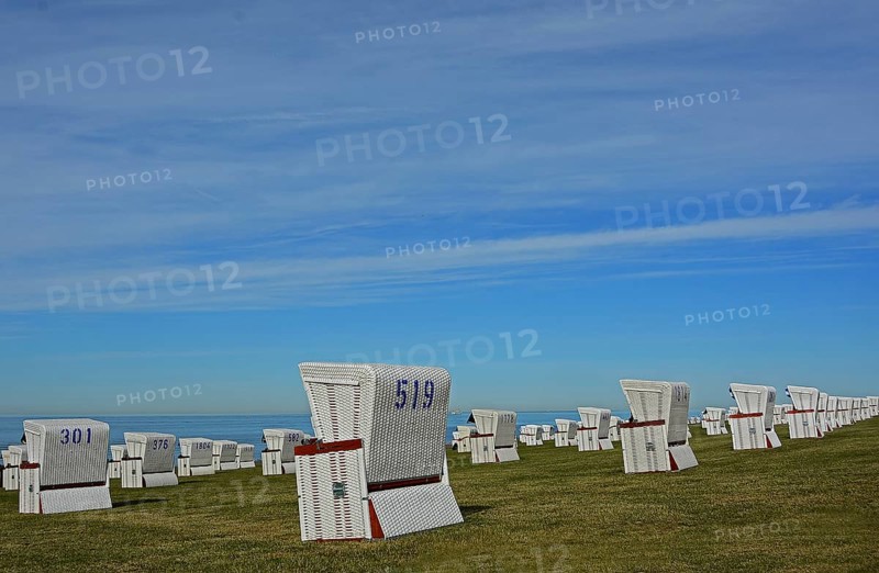 White beach chairs at the dike