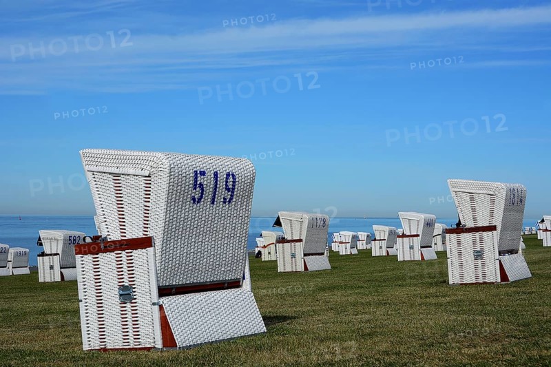 White beach chairs at the dike