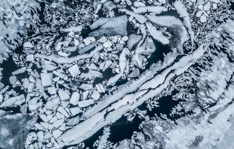 Partly frozen lake with ice floes