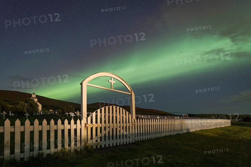 Northern lights over church and cemetery