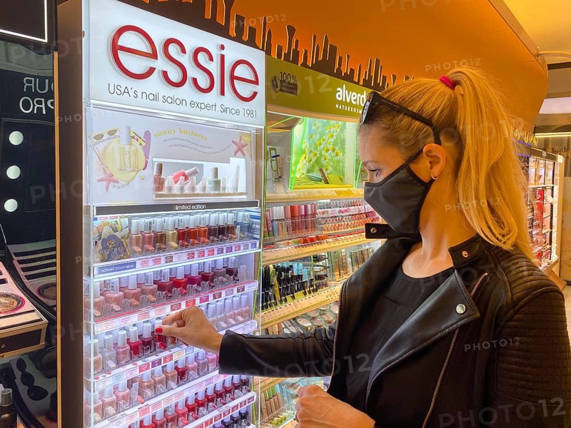 Woman wearing a face mask while shopping in the cosmetics department