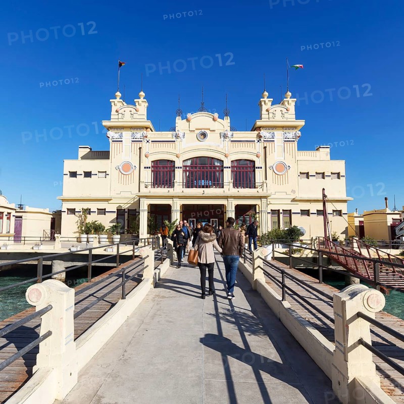 Tourists go on pier to the former bathhouse