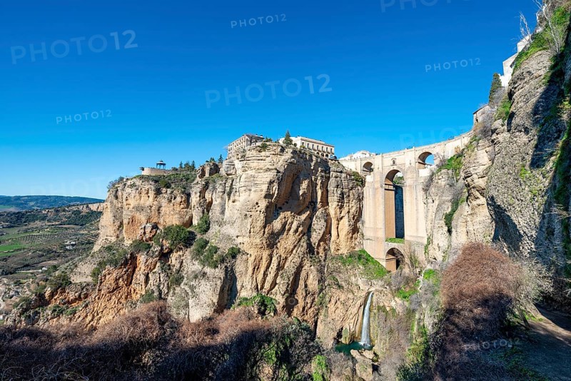 Bridge Puente Nuevo with waterfall at steep cliffs