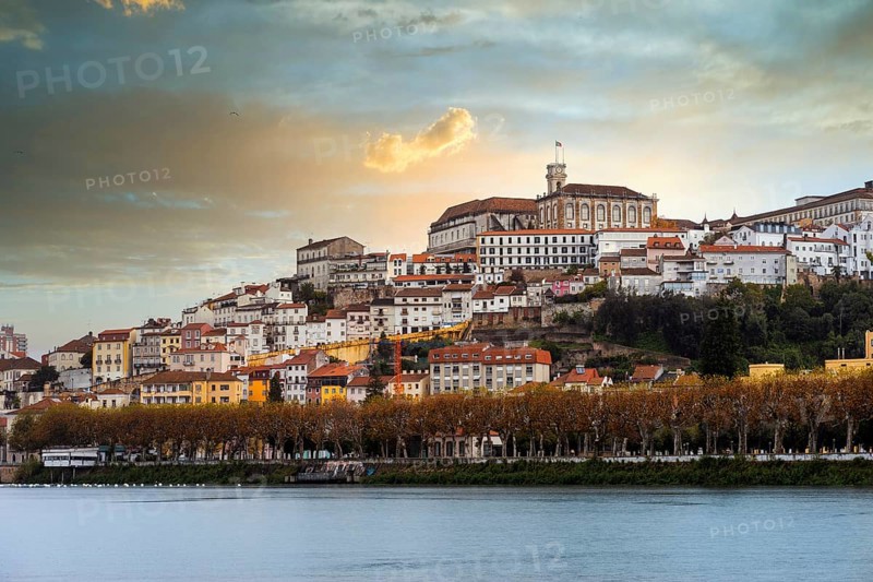 Coimbra cityscape with Mondego river by sunset