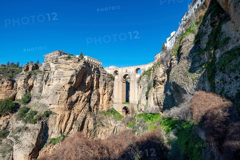 Bridge Puente Nuevo with waterfall at steep cliffs