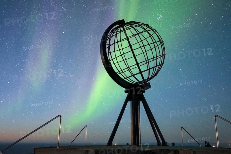Steel globe at North Cape with northern lights