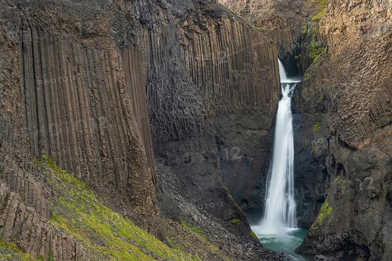 Waterfall Litlanesfoss between columnar basalt