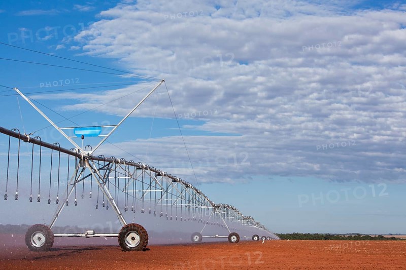 Pivot Sprinklers spread water on cotton harvested fields