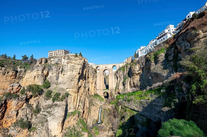Bridge Puente Nuevo with waterfall at steep cliffs