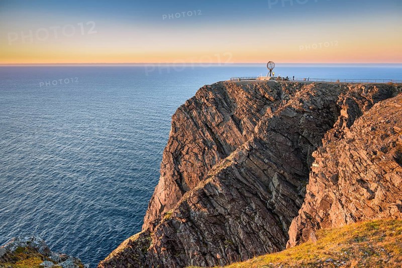 North Cape cliff with steel globe in the light of the midnight sun