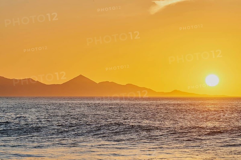 Rocky coast near beach Playa de la Pared at sunset