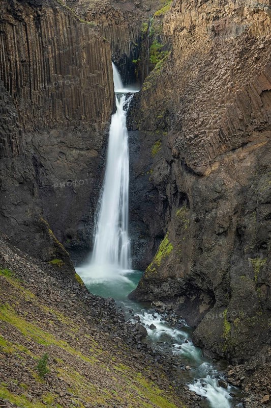 Waterfall Litlanesfoss between columnar basalt