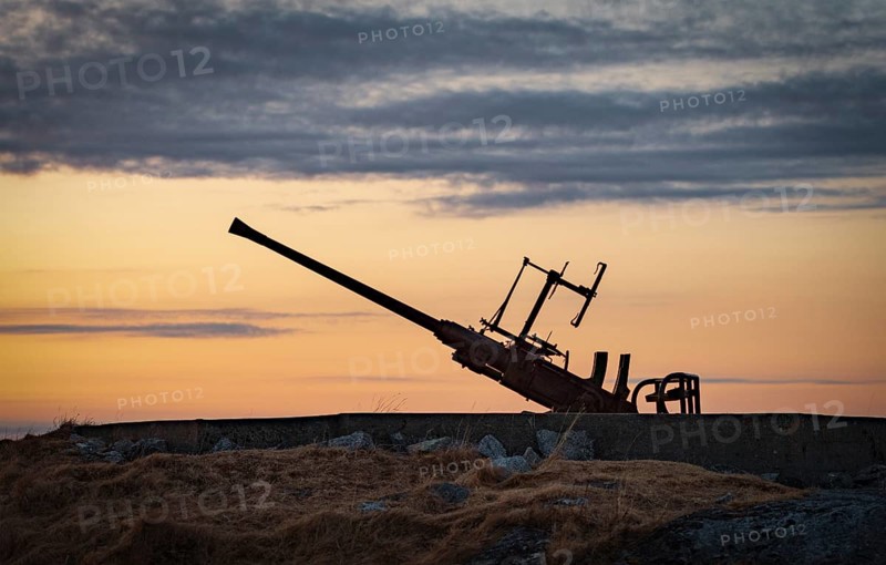 Anti-aircraft gun position at the sea from the 2nd world war against the light of the evening sun