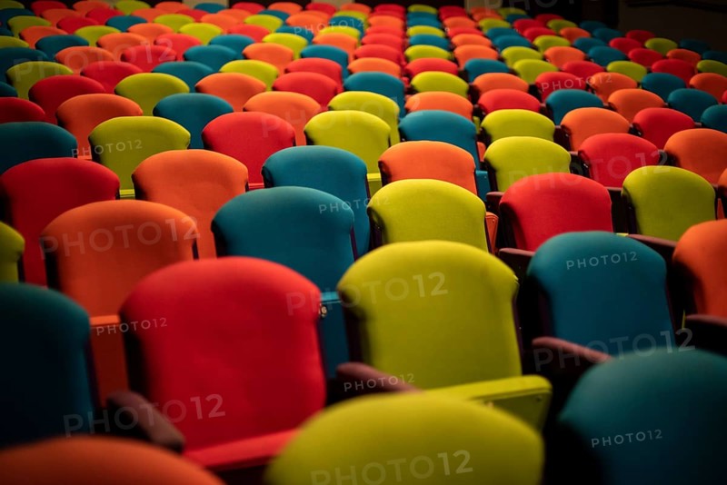 Colourful chairs in the empty auditorium
